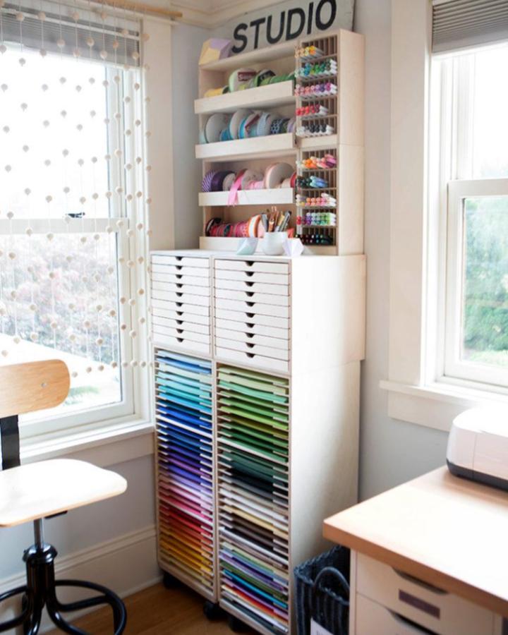 Rainbow paper tower craft room from Lia Griffith. Bright drawers and tidy shelves.