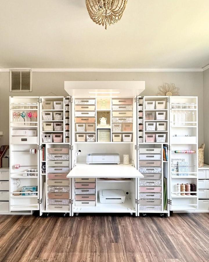 white and blush Dream Box craft station from @createwithdesi. Neat bins, open shelves, and a central work surface.