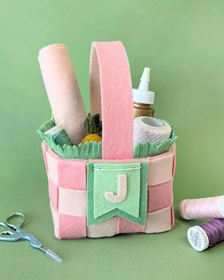 Pink and green felt woven basket from @benziedesign filled with craft supplies for easter basket ideas.