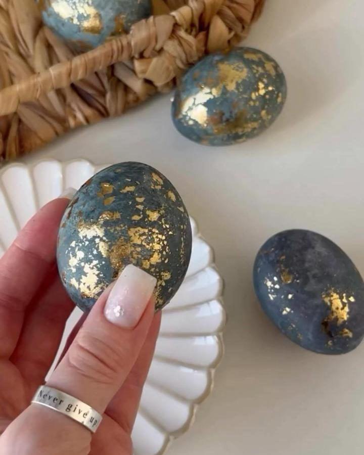 Gold leaf accented moody blue Easter eggs from @make_a_wish_ua with artistic irregular gold patches.