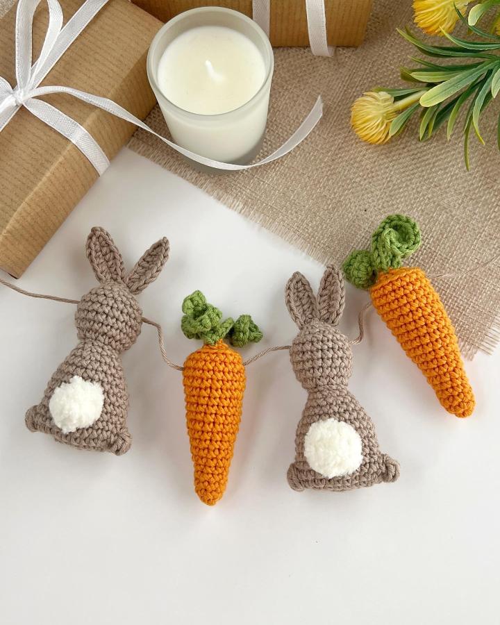 Crochet bunny and carrot garland with fluffy tails from @amiguide_store. Bright yarn easter garland ideas for a cozy spring vibe.