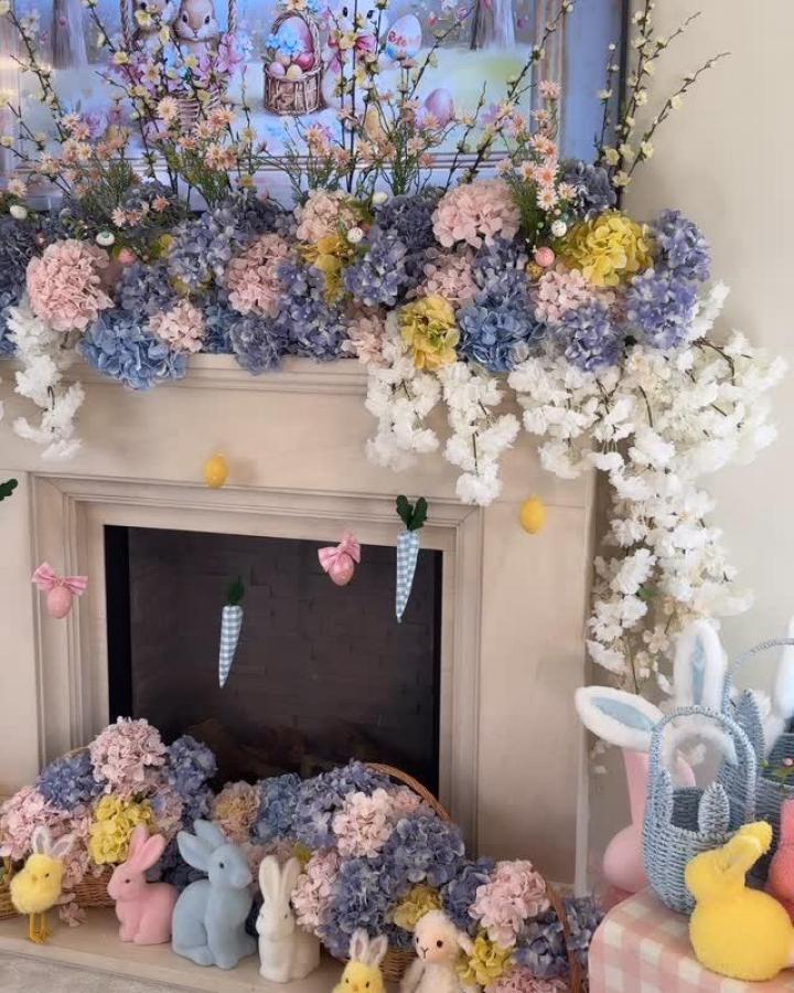 Pastel hydrangea and white blossoms mantel floral arrangement with soft fabric carrots and eggs from @thesleepoverclub_ featuring easter mantel decor ideas
