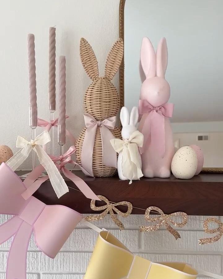 Wicker bunny with pastel pink ribbon on mantel from @stonemountaincastings for easter mantel decor ideas.