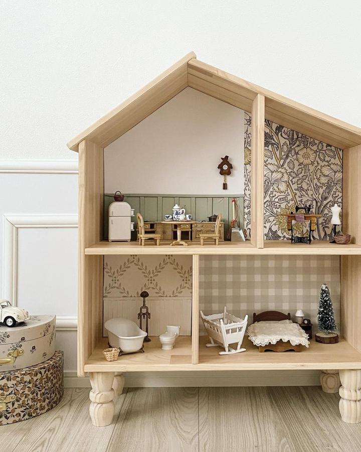 natural wood dollhouse with vintage miniature furniture from @_____snooze. cozy rustic home setting with floral and plaid wallpapers
