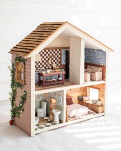 muted pastel painted Ikea Flisat dollhouse hacks & ideas from @genevavanderzeil with floral wallpaper and handcrafted wooden shingles exterior