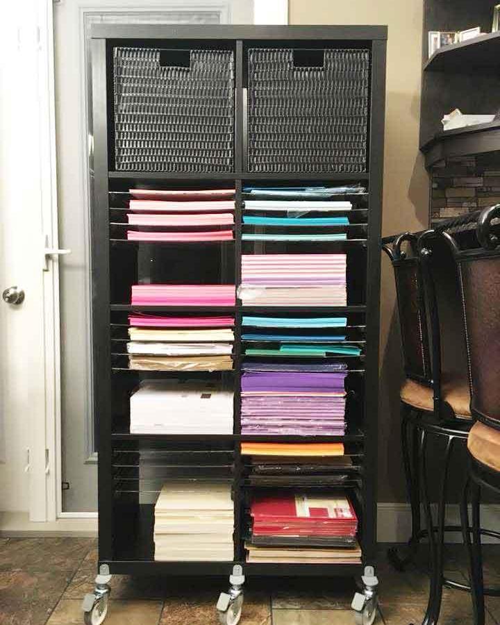 Black Ikea Kallax craft room ideas shelving unit with wheeled base and colorful paper storage inspired by That Paper Flower Chick.