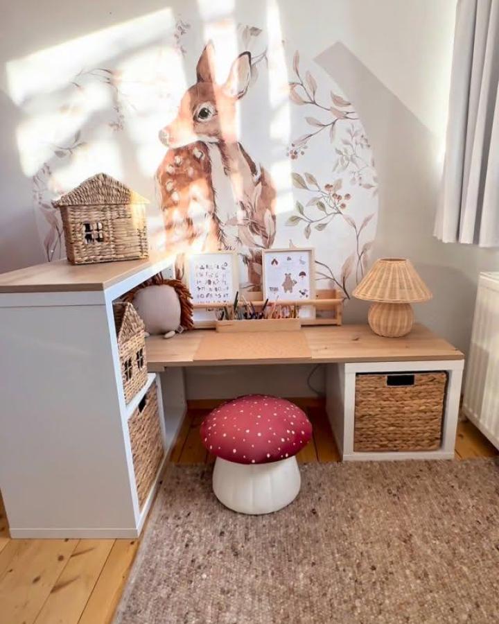 natural wood and white ikea kallax toy storage ideas desk from @kreativbabs. Woven baskets, deer mural, and mushroom stool keep it playful