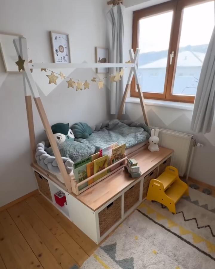 white and wood childrens nook from @kreativbabs. Cozy Kallax bed with toy storage and woven baskets.