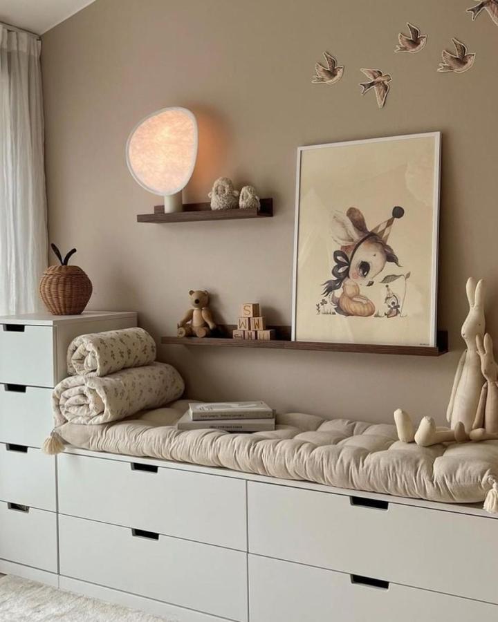 beige tufted cushion on white drawer bench in cozy room from @ikeahackersdiy with warm wood shelves and soft lighting