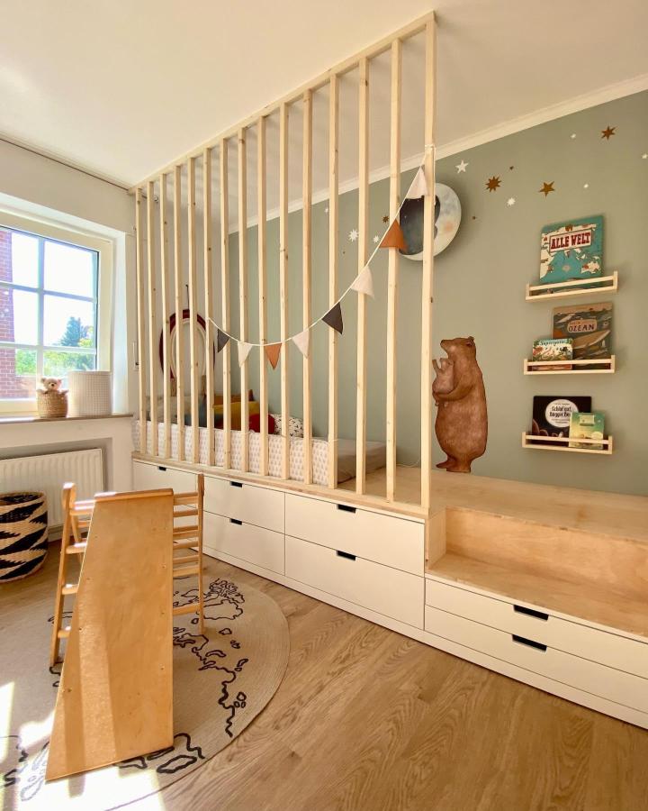 natural wood and white drawer children's loft bed in playroom from @wir_sind_detailverliebt with star wall stickers and storage drawers IKEA nordli hacks & ideas