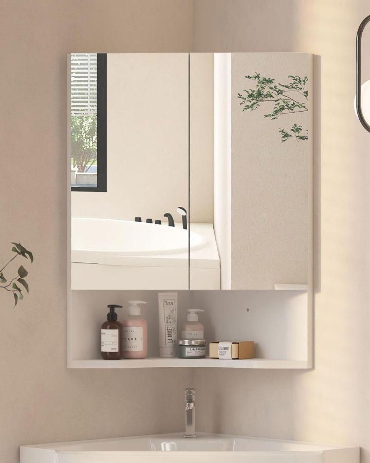 White modern corner mirror cabinet with open shelf in small bathroom from One Clear Winner. Compact design blends storage and reflection perfectly for bathroom mirror ideas for small spaces.