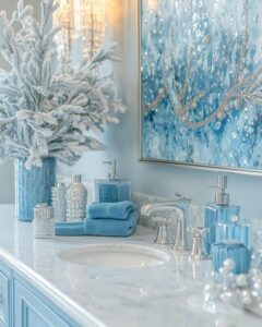 Glacial blue bathroom accessories on marble countertop from Courtneys World with frosted decor and silver fixtures creating blue bathroom decor ideas ambiance