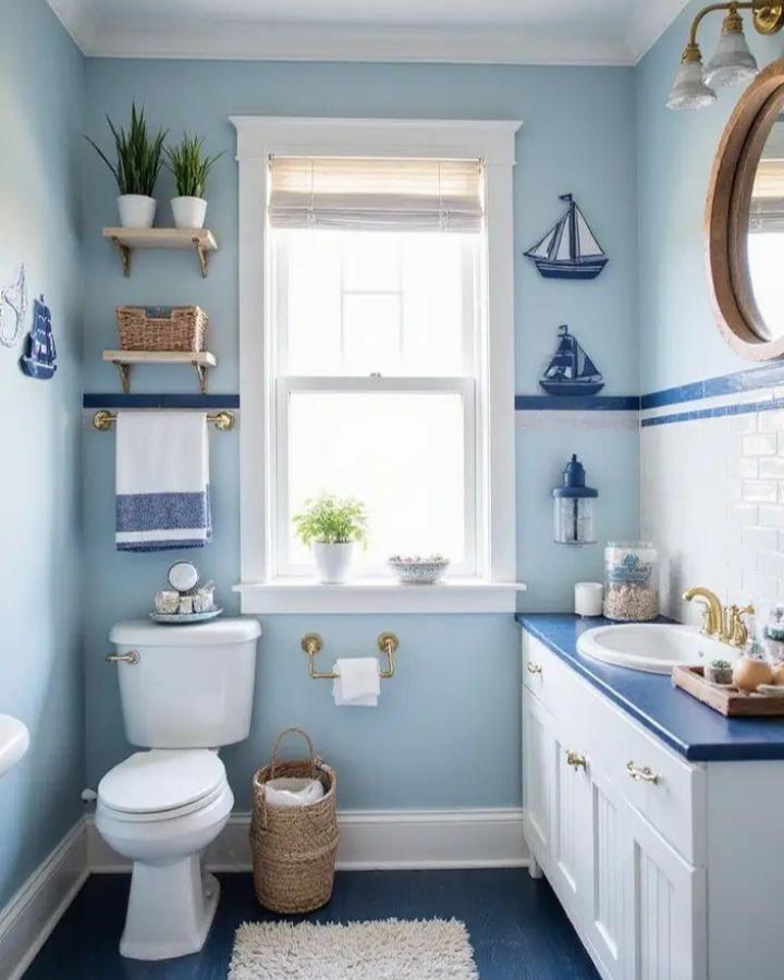 Soft sky blue bathroom with classic nautical pirate ship decorations from Kidlura. Cozy, bright, and inviting blue bathroom decor ideas.