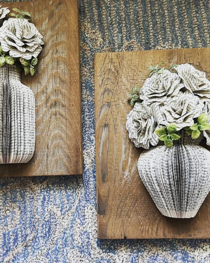 Vintage-style paper flower vases on rustic wood backboards from Lynne's Library. Book page home decor crafts with intricate folded paper roses.