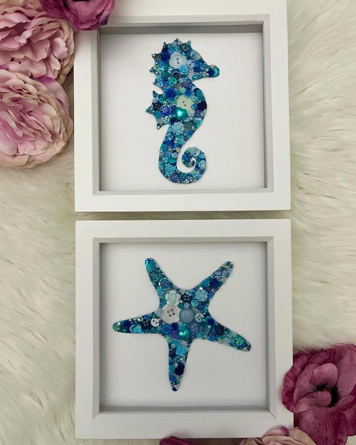 Blue and teal button seahorse and starfish wall art in white frames from @buttonartbyamy with floral accents for button crafts for adults.