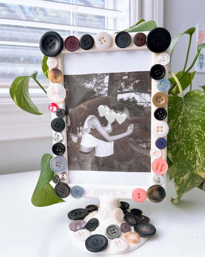 Button covered photo frame with mixed black white pastel buttons from @bleachsketches showing button crafts for adults with playful vintage charm and texture variation
