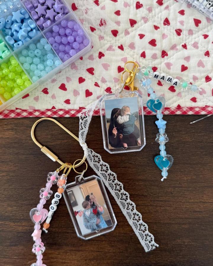 Pink blue and lavender beaded keychains with personalized letter beads and photo frames from @sammcamp_ for craft night themes for adults showing delicate lace and heart motifs.