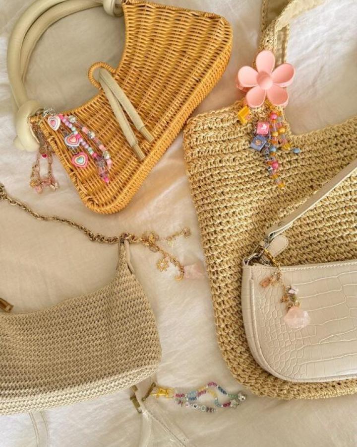 Woven and leather bags adorned with pastel beaded charms from Maxie Elise enhancing craft night themes for adults with playful DIY details