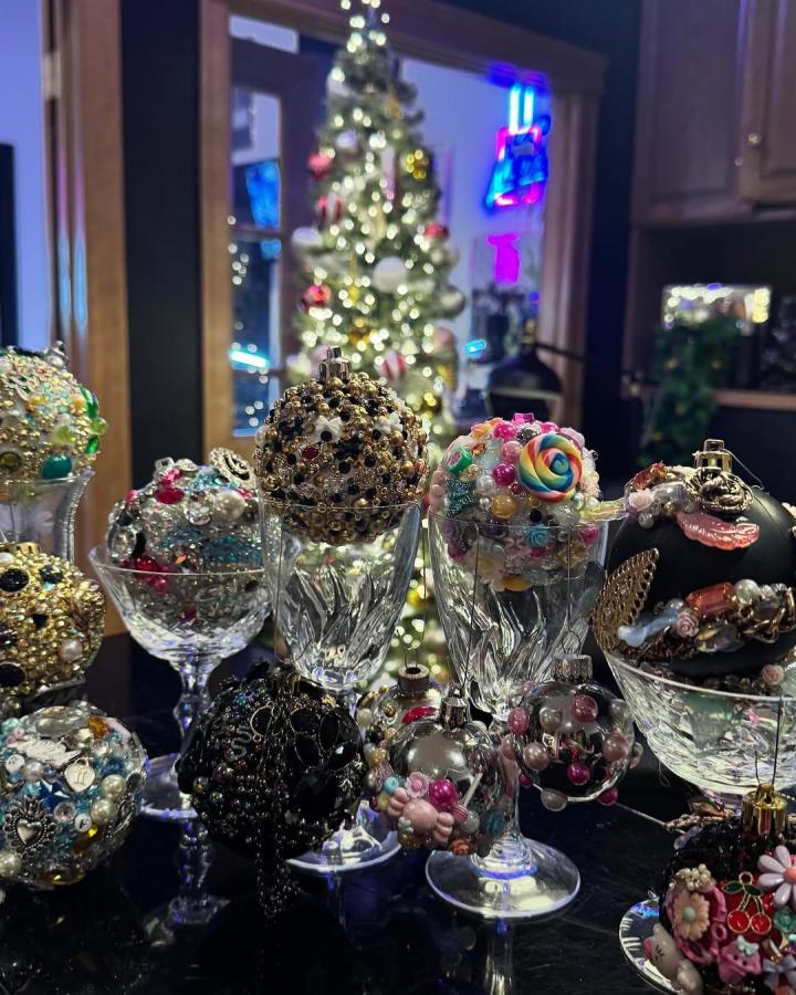 Bejeweled and colorful holiday ornaments displayed on crystal glasses from @delaneyjade. Craft night themes for adults with eclectic, festive decoration style.