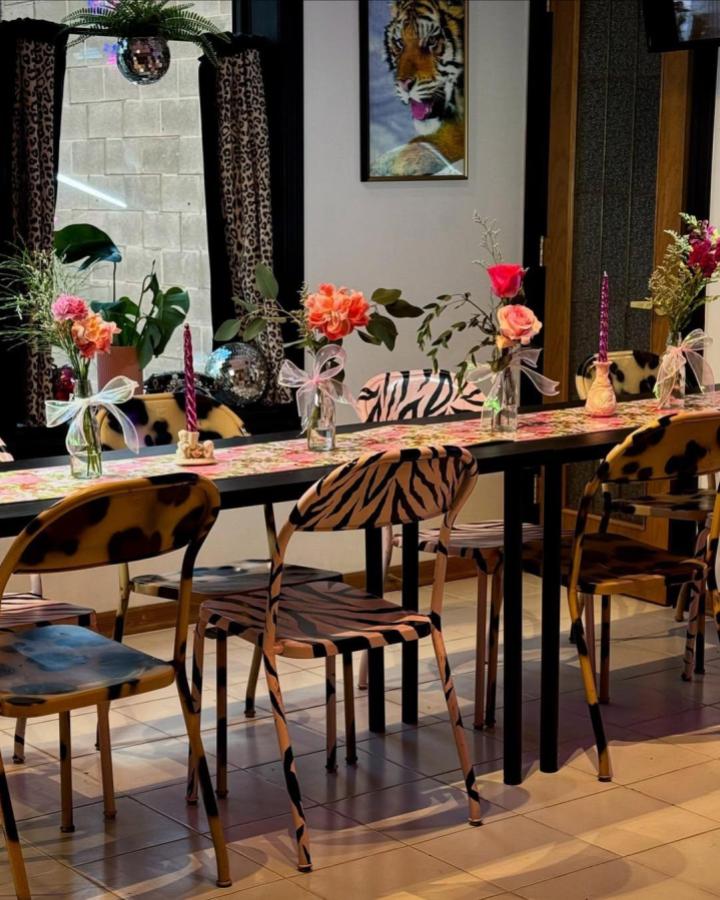 Wild animal print chairs and fresh flowers from @delaneyjade set a lively mood for craft night themes for adults.