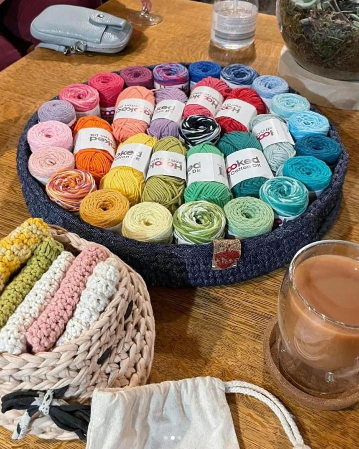 Assorted colorful cotton yarns in denim basket from A Heart Shape Cherry. Organized for craft night themes for adults inspiration and creativity.