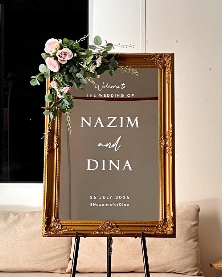 Ornate gold framed mirror wedding welcome sign decorated with pink roses and greenery from Wedding Welcome Signs KL diy wedding welcome sign ideas elegant and classy
