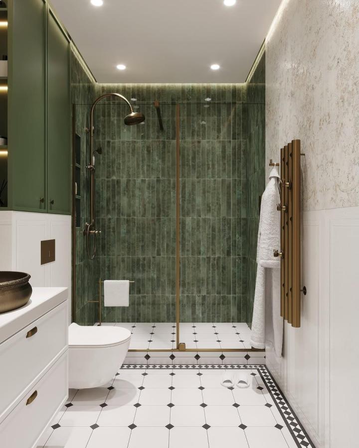 green ceramic tile bathroom from @timaxceramics_spanish_tiles with brass fixtures and white patterned floor tiles green bathroom decor ideas