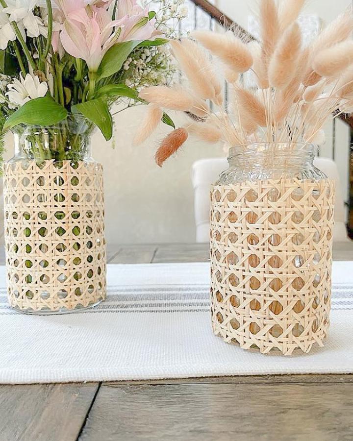Light beige cane wrapped mason jar crafts for adults with fresh and dried flowers by My Uncommon Slice of Suburbia in a cozy indoor setting.