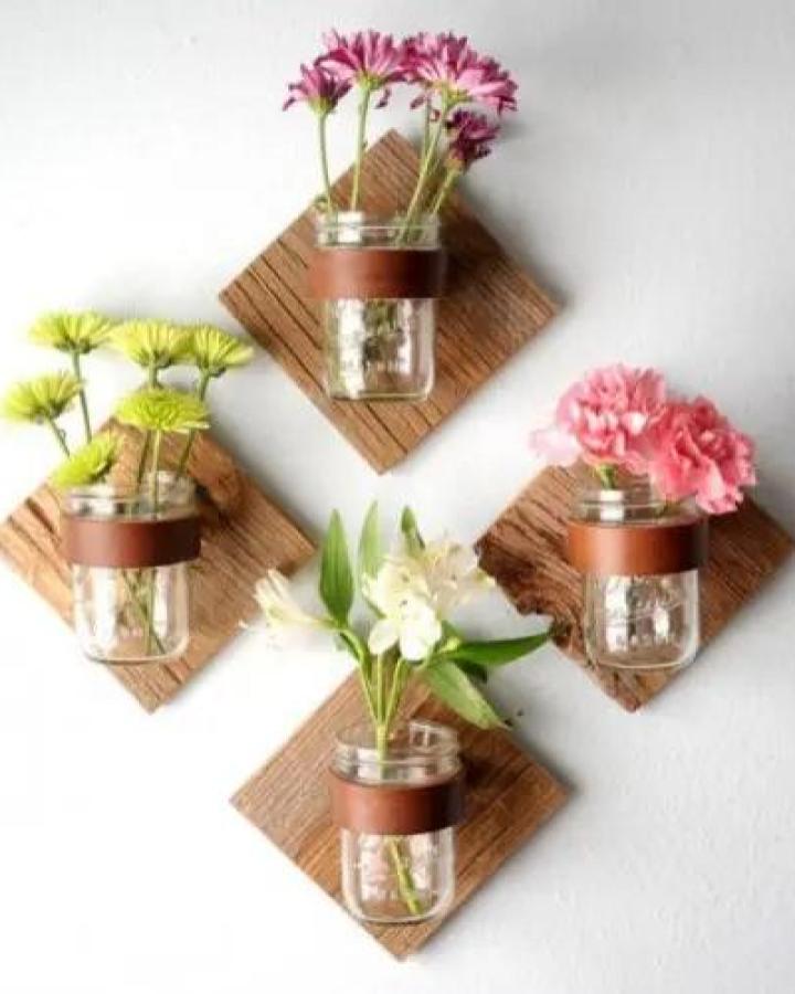 rustic wood and leather mason jar crafts for adults mounted on white wall holding fresh flowers from Shelterness bright and simple floral display