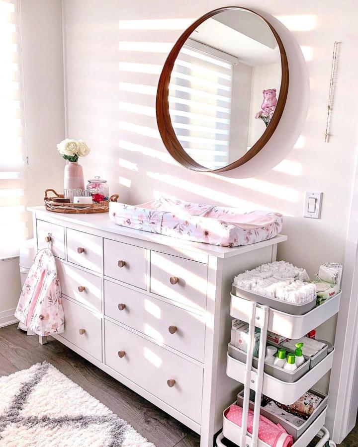 white dresser and rolling cart nursery storage ikea nursery storage ideas from @ashleyidalia soft natural light bright and organized baby room setup
