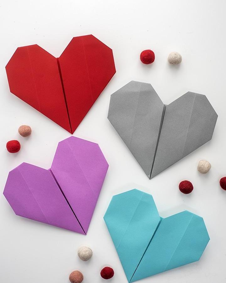 red purple gray and blue origami hearts with felt balls from aliceandlois mindful crafts for beginners simple paper folding project for calm creativity