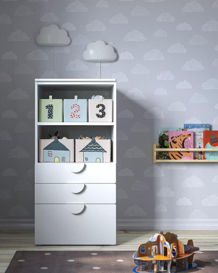 pastel storage boxes with numbers and houses in ikea nursery storage ideas from @nested.lb bright, playful nursery shelf setup with toy storage and book display