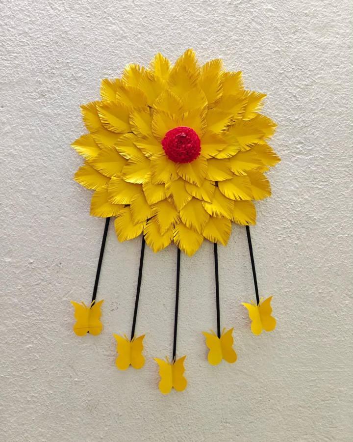 Bright yellow and red paper flower wall hanging with dangling butterflies from @creativesuu. Textured petals and playful charm in paper crafts for adults.