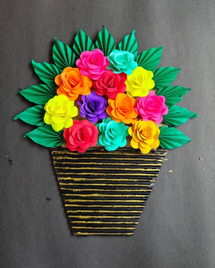 Bright multicolor paper flowers and green leaves in a striped basket paper craft from @creativesuu showing vibrant paper crafts for adults artistry.