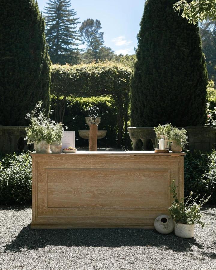 rustic wooden wedding bar ideas with greenery and potted plants from @blushtype in outdoor garden setting