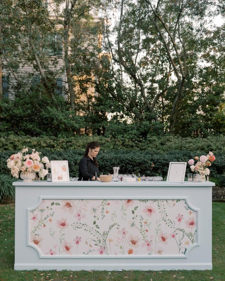 Pastel blue wedding bar with floral paneling and peach pink bouquets from @studiordesign outdoor garden wedding bar ideas setup