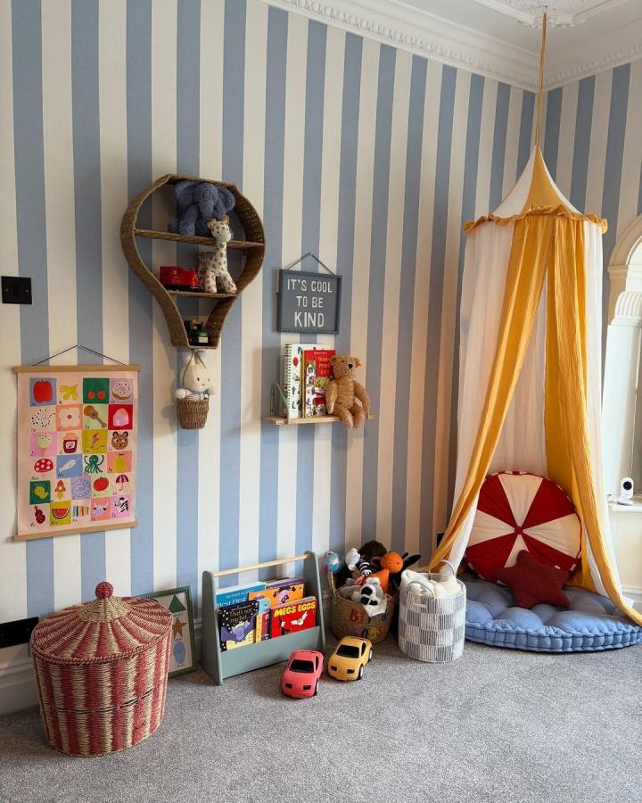mustard yellow and white fabric canopy nook in circus nursery ideas from @lucywardropper soft floor cushion and circus-inspired pillow under canopy