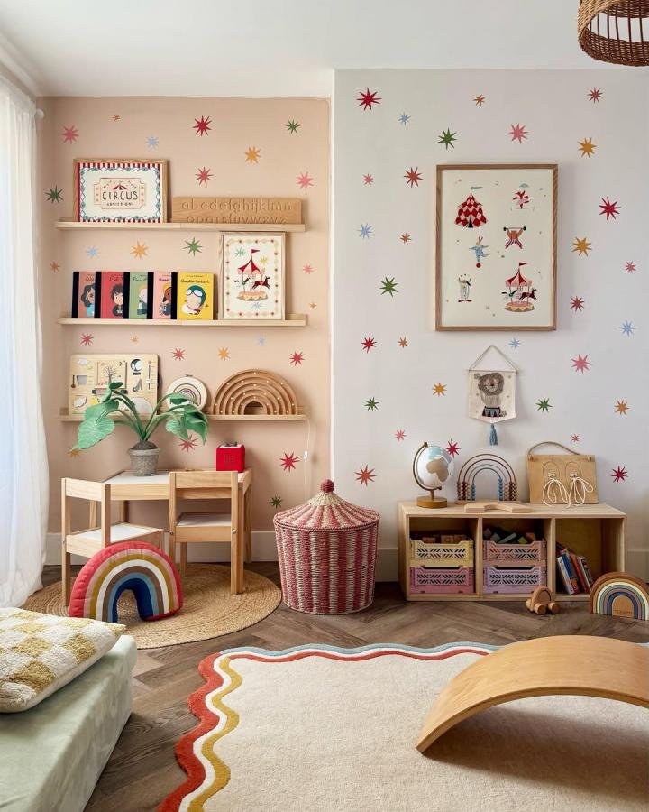 soft pastel star wall decals and wooden toys from @kidofthevillage in a circus nursery ideas room with rainbow cushions and warm natural accents