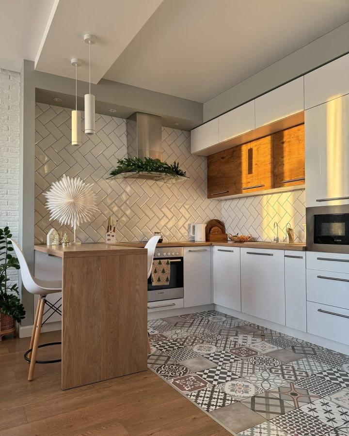 Wood and white compact kitchen island with stool and patterned floor by @maria_h.o.m.e showcasing ikea kitchen island hacks in modern kitchen setting