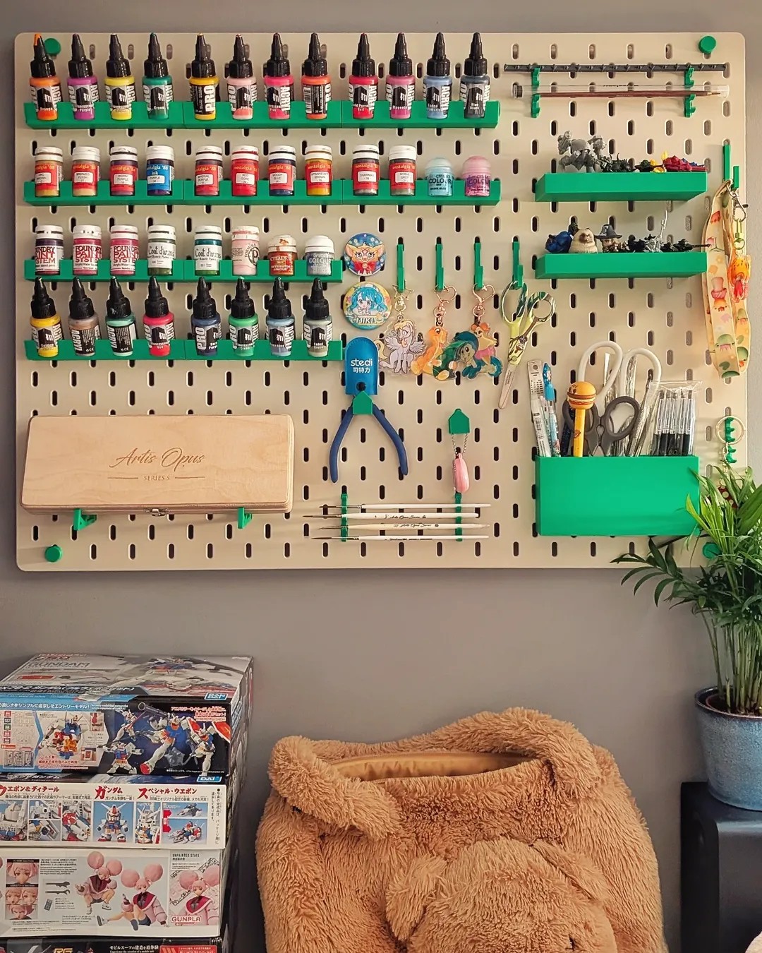 green wooden shelves and pegboard ikea skadis craft room ideas from @savage_ork_guy with organized paints and tools in bright green holders
