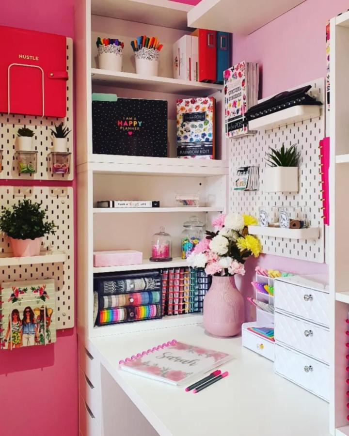 Pink and white Ikea Skadis craft room ideas with pegboards and colorful supplies from @sarah.plans.her.life showcasing organized creativity.