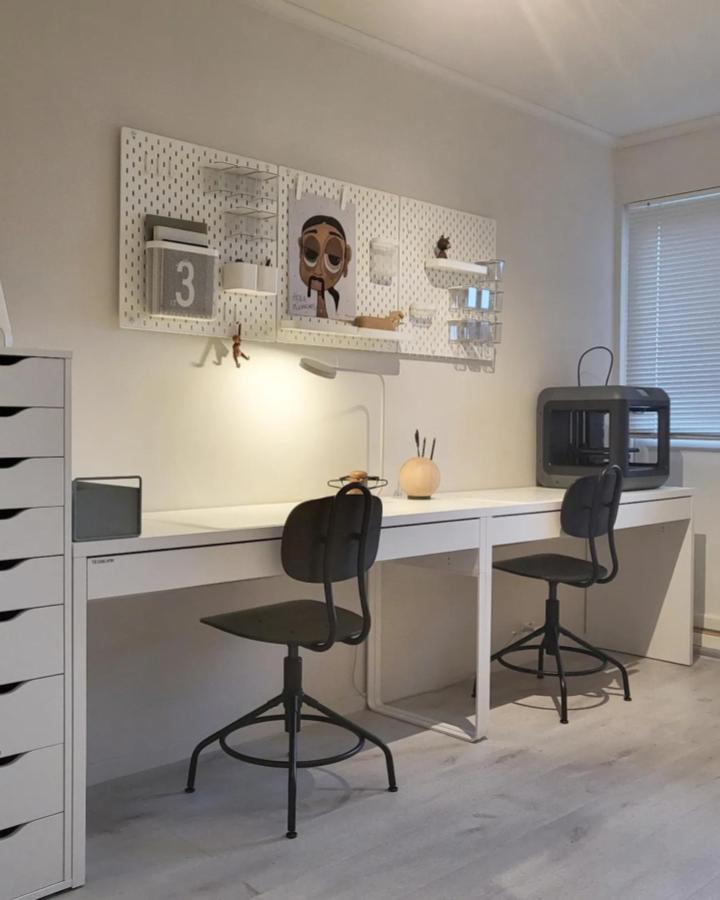 white minimalist Skadis pegboards and black chairs in craft room from @maa1983. Organized modern ikea skadis craft room ideas with acrylic storage.