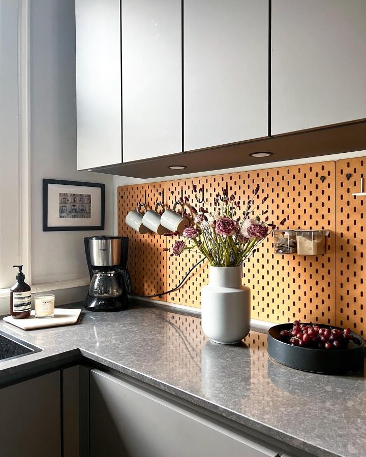 Terracotta pegboard kitchen workspace from @katamo_interiors with hooks and storage exemplifies ikea skadis craft room ideas in warm tones.