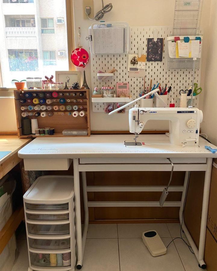 white Ikea Skadis pegboard craft room setup from @k_house_handmade with sewing machine and organized supplies for ikea skadis craft room ideas