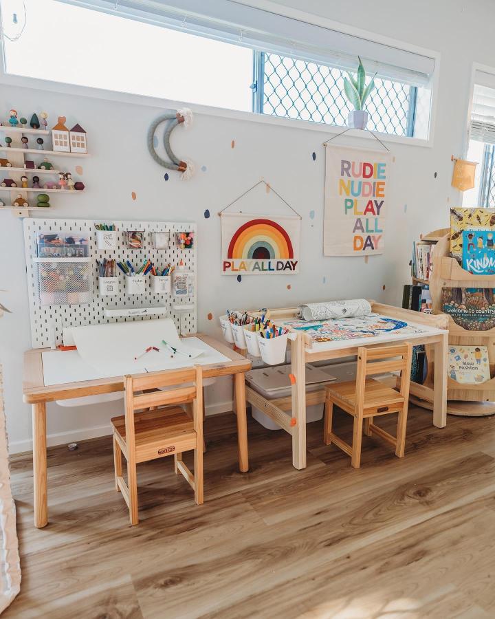 White Skadis pegboard craft table setup from @gemma.leigh.r with colorful supplies and child-sized furniture ikea skadis craft room ideas bright and organized.