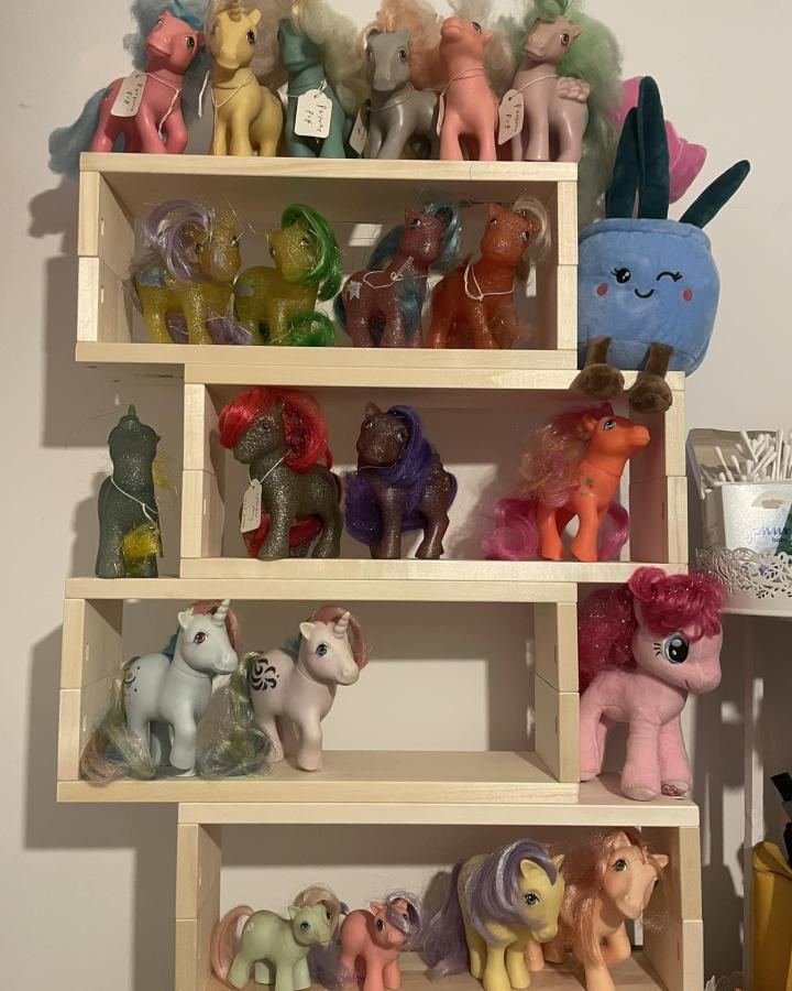 Natural wood stacked shelves holding colorful toy ponies and plushies inspired by a spice rack arrangement for creative storage and display by Iona Ball.