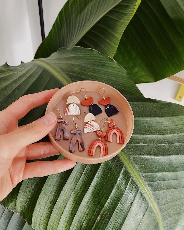 Terracotta, beige, black, and marbled polymer clay earrings ideas by @helloimlisa featuring abstract shapes and rainbow motifs.