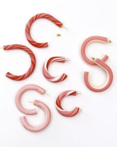 Pink and red swirled polymer clay hoop earrings in various sizes from persia lou. Bold patterns and smooth matte finish hoops for stylish accessories.