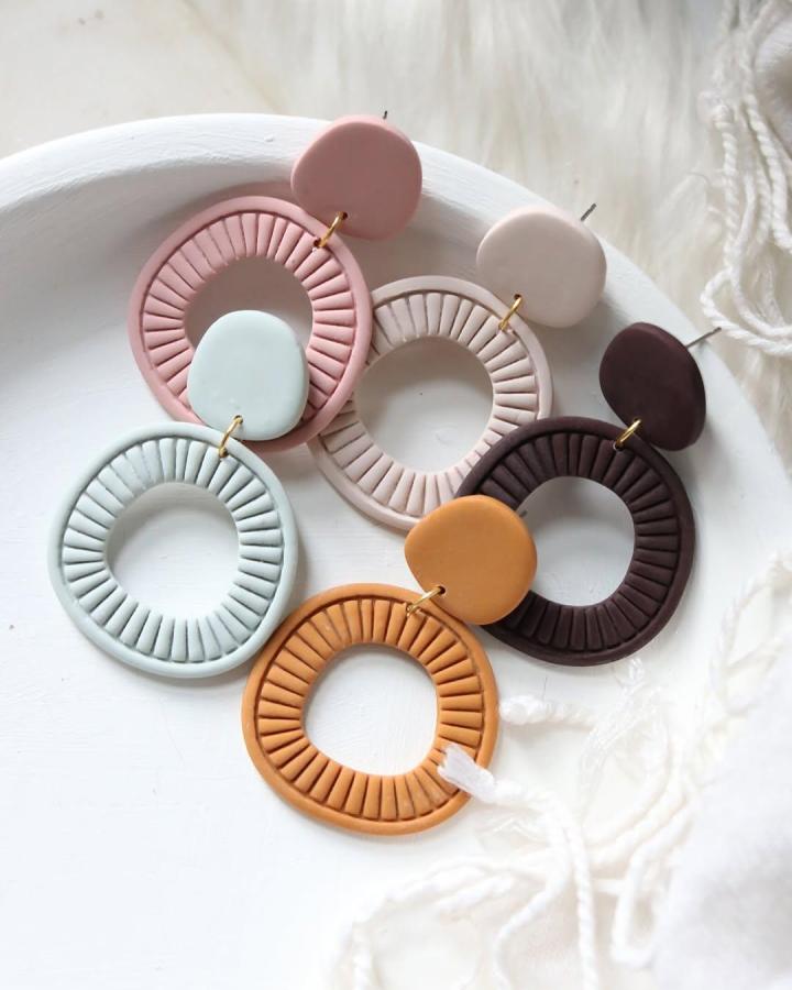 Textured pastel and earthy tone polymer clay earrings with circular hoops and raised ridges by @shoppetalandposy.