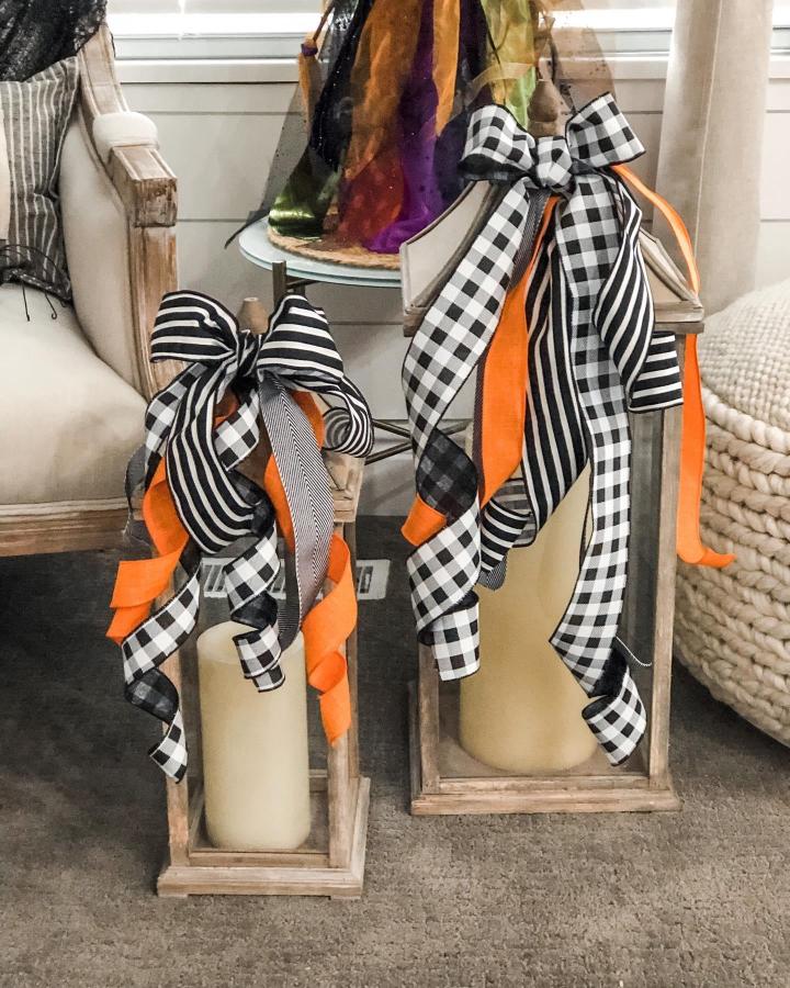 Black white striped and checked ribbon lantern decorations with orange accents from @citygirlmeetsfarmboy featuring ribbon crafts for adults, festive and rustic style.